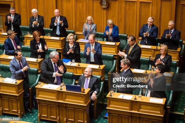 Steven Joyce, New Zealand's finance minister, center bottom, receives a standing ovation after delivering the budget in Parliament in Wellington, New...