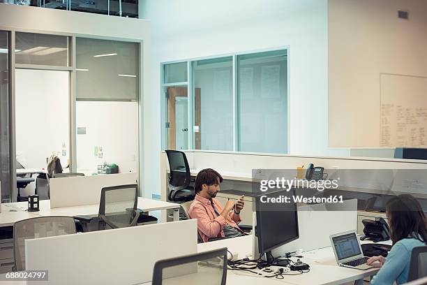 people working in office, using mobile devices - mühsal stock-fotos und bilder