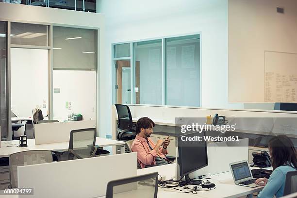 people working in office, using mobile devices - drudgery stock pictures, royalty-free photos & images