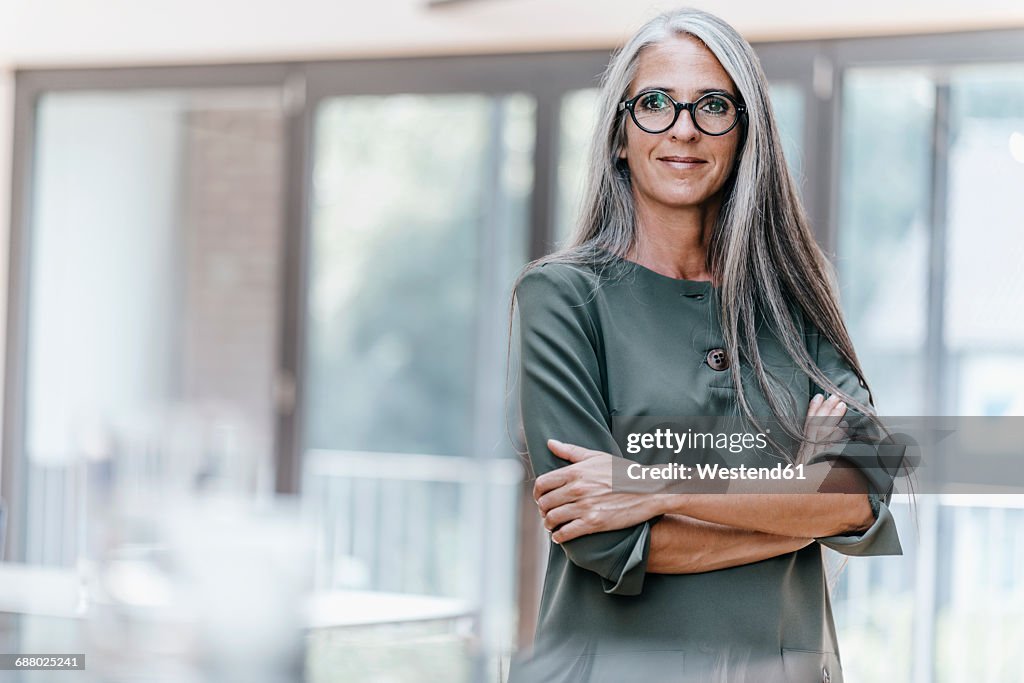 Portrait of smiling woman with long grey hair