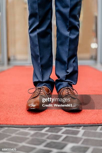 businessman standing on red carpet, partial view - smart shoes stock pictures, royalty-free photos & images
