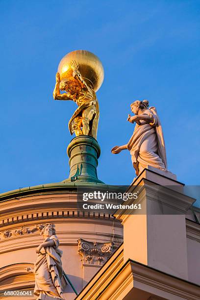 germany, potsdam, gold plated atlas on roof top of old city hall - potsdam brandenburg stock-fotos und bilder