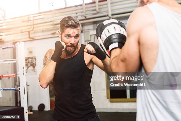 boxer sparring with coach - sparring stock-fotos und bilder