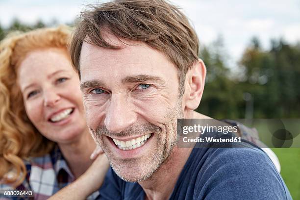 portrait of smiling couple outdoors - baby boomer couple stock-fotos und bilder