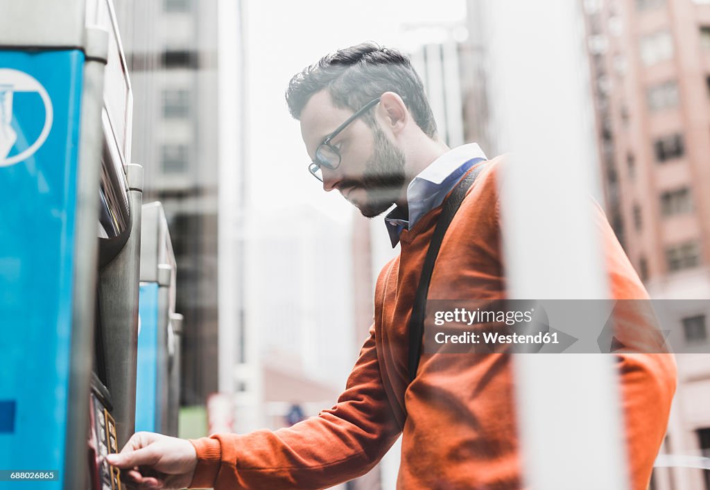 USA, New York City, Businessman using ATM
