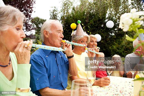 extended family and friends having birthday party in garden - mid adult stock pictures, royalty-free photos & images