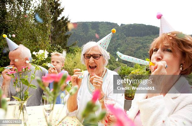 seniors celebrating birthday oarty in garden - ages 65 70 stock pictures, royalty-free photos & images