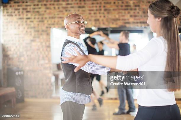 dance instructor teaching class in studio - ballroom dance stock pictures, royalty-free photos & images