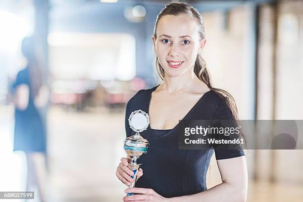 portrait of confident female tango dancer holding trophy - honors awards 2016 show stock pictures, royalty-free photos & images
