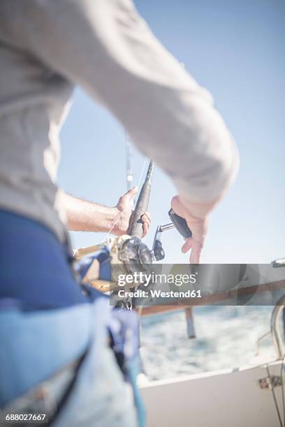 close-up of man on boat deep sea fishing - deep sea fishing stock-fotos und bilder