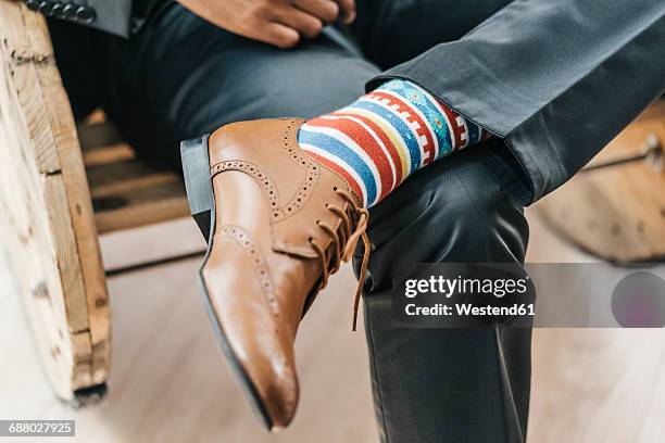 young businessman sitting with legs crossed - smart shoes stock pictures, royalty-free photos & images