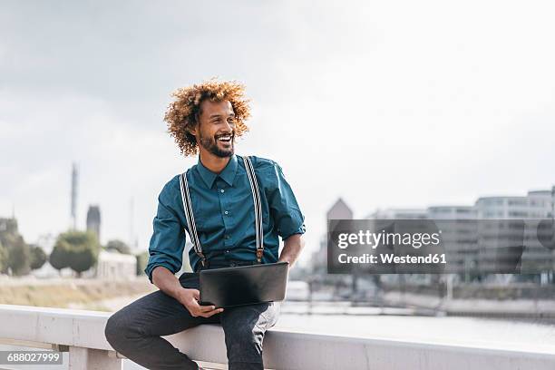 young man using laptop outdoors - suspenders stock pictures, royalty-free photos & images
