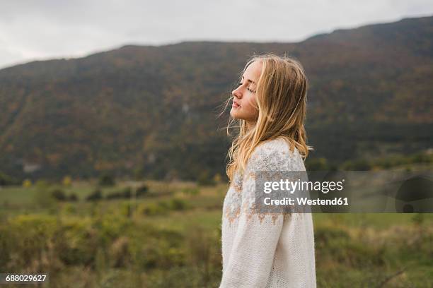 young woman wearing pullover outdoors - eyes closed bildbanksfoton och bilder