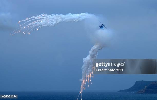 Made Apache helicopter releases flares during the "Han Kuang" life-fire drill, some 7 kms from the city of Magong on the outlying Penghu islands on...