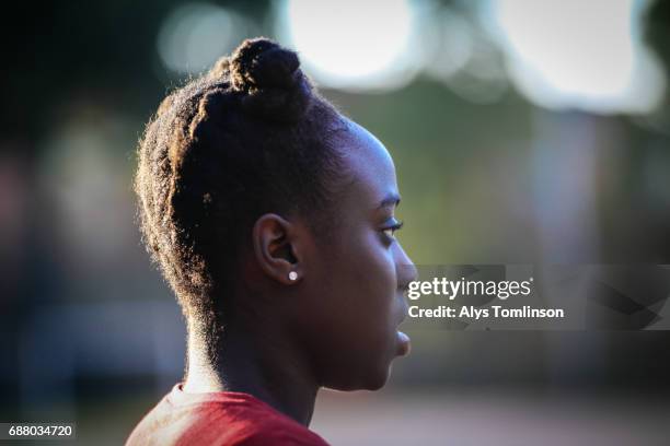 profile portrait of young woman on outdoor sports court - black woman profile pic stock pictures, royalty-free photos & images