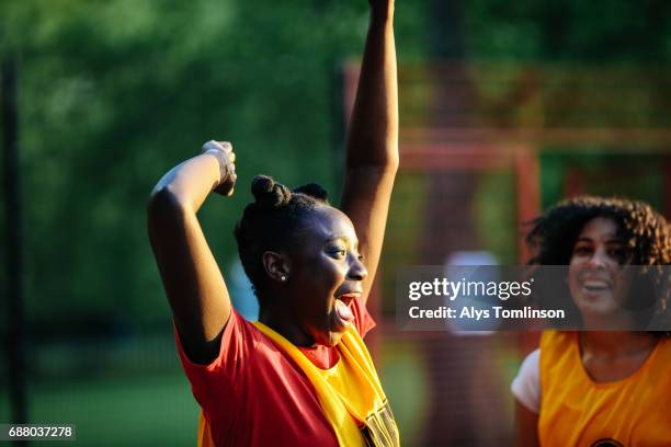 young netball player celebrating win on netball court - community sport stock-fotos und bilder