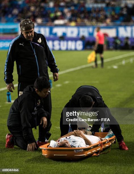 Koki Ogawa of Japan lies injured next to the pitch during the FIFA U-20 World Cup Korea Republic 2017 group D match between Uruguay and Japan at...