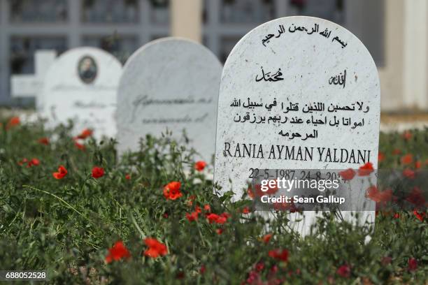 Tombstone at the grave of Rania Ayman Yaldani lies among graves that, according to the cemetery caretaker, are the graves of migrants who died while...