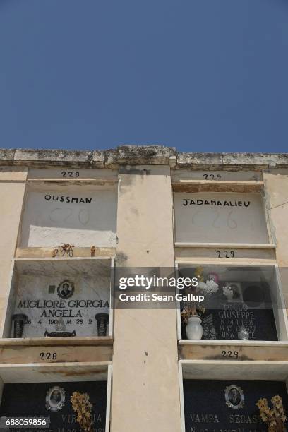 The tombs of people identified as Oussman and Jadamaalieu, who, according to the cemetery caretaker, are migrants who died while trying to reach...