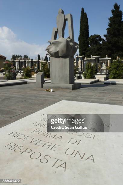 Monument stands among tombs that contain the bodies of migrants who died while trying to reach Italy in the municipal cemetery on the island of...