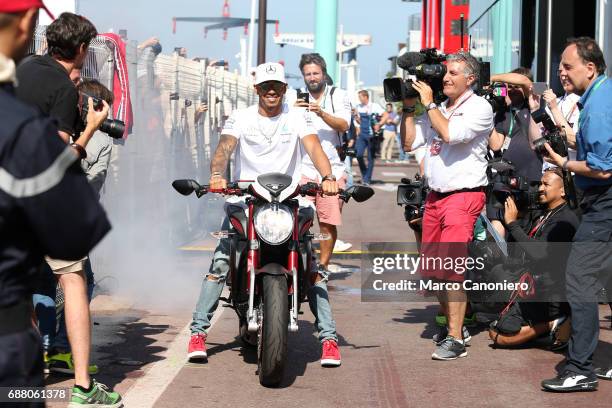 Lewis Hamilton of Mercedes AMG Petronas F1 Team make a burnout with his motorbike in the Paddock during the Monaco Formula One Grand Prix.