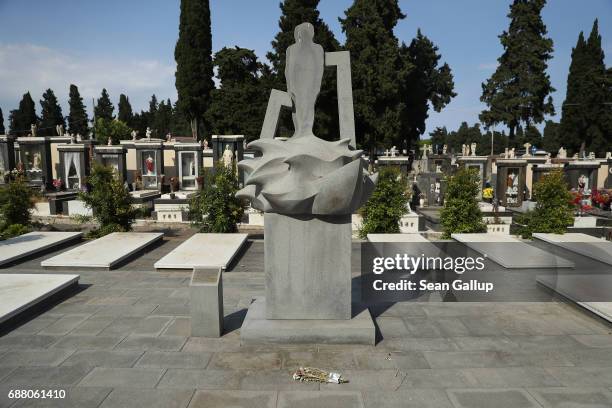 Monument stands among tombs that contain the bodies of migrants who died while trying to reach Italy in the municipal cemetery on the island of...