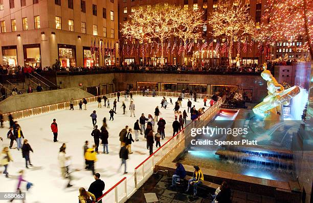 Ice skaters enjoy a festive evening at the ice rink at Rockefeller Center December 17, 2001 in New York City. While security is a little tighter this...