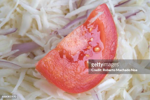 Healthy eating: Shredded cabbage salad garnished with slice of red tomato. Low calorie and high dietary fiber plate.