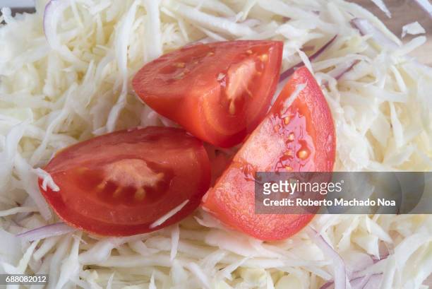 Healthy eating: Shredded cabbage salad garnished with slice of red tomato. Low calorie and high dietary fiber plate.