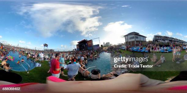 Festivalgoers lounge in the pool and green grass VIP area during the 2017 Hangout Music Festival on May 19, 2017 in Gulf Shores, Alabama.