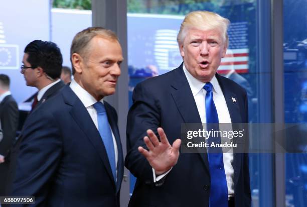 President Donald Trump gestures as he welcomed by European Council President Donald Tusk , as part of the NATO meeting, in Brussels, Belgium on May...