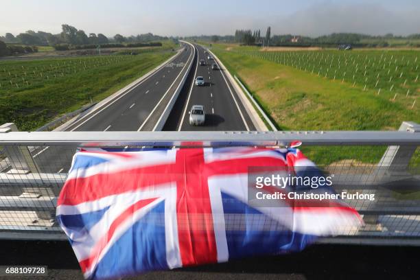 Union flag, in honour of the Manchester attack victims, flies from a motorway bridge as communters make their way into Manchester on May 25, 2017 in...