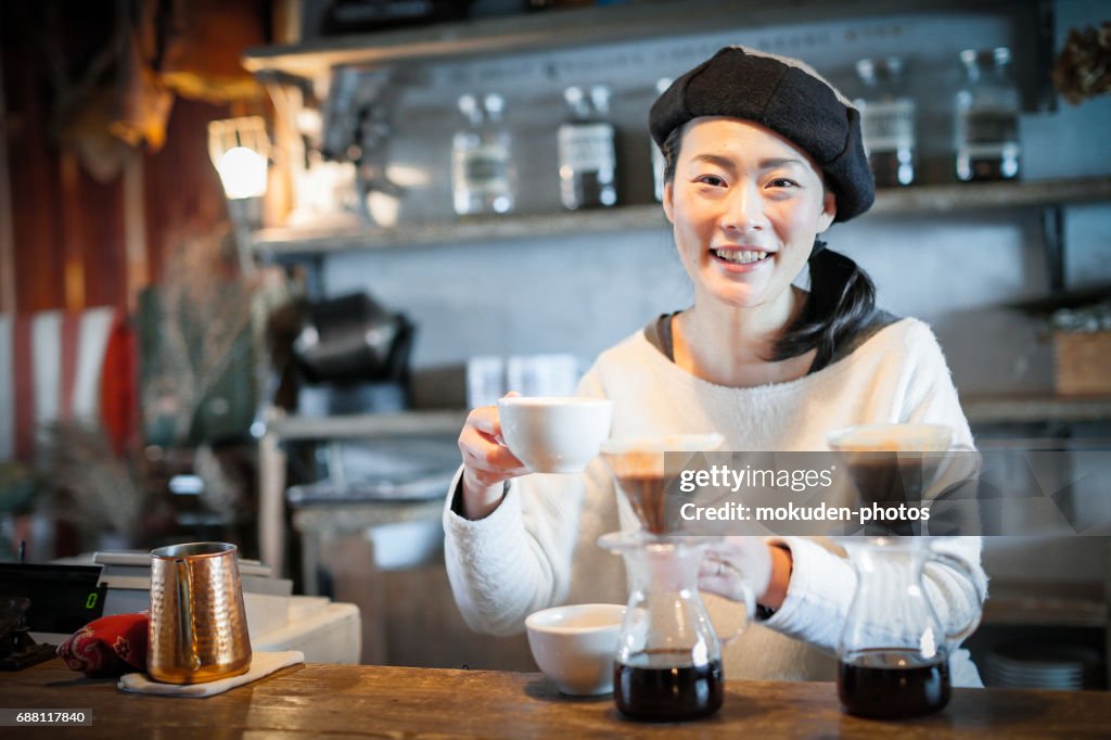 Happy Japanese woman cafe owner
