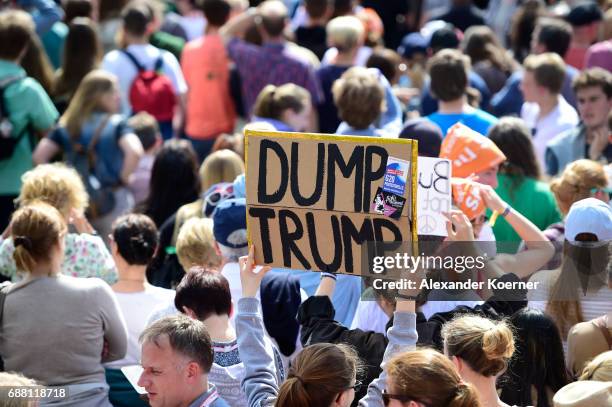 Visitors hold up a banner "Dump Trump" prior the arrival of former President of the United States of America, Barack Obama and German chancellor...