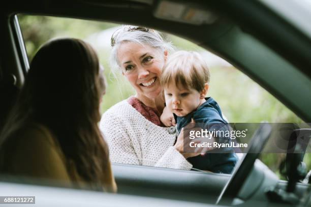 mother leaving child with grandmother - nanny stock pictures, royalty-free photos & images