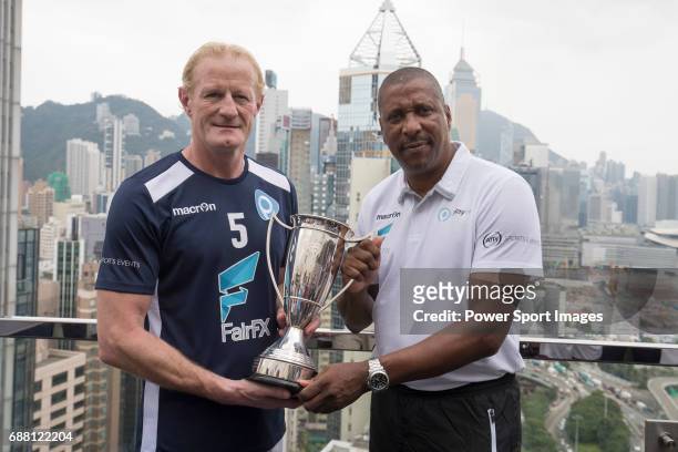 PlayonPROS's Colin Hendry and Viv Anderson pose for a photograph in front of Hong Kong's urban landscape to celebrate the launch of the HKFC Citi...