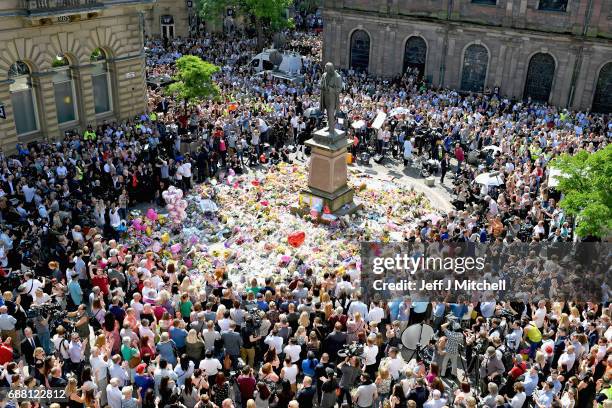 Members of the public observe a national minute's silence in remembrance of all those who lost their lives in the Manchester Arena attack, on May 25,...