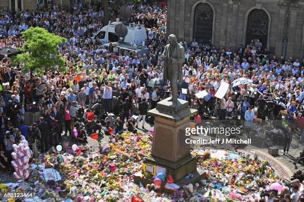 Members of the public observe a national minute's silence in remembrance of all those who lost their lives in the Manchester Arena attack, on May 25,...
