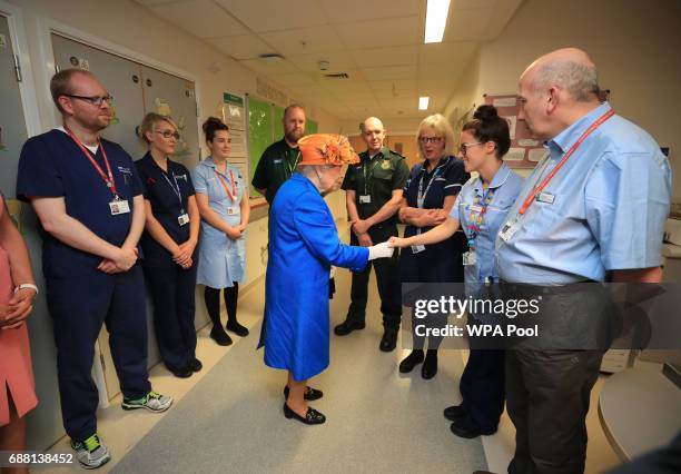 Queen Elizabeth II shakes hands with a nurse during a visit to the Royal Manchester Children's Hospital on May 25, 2017 in Manchester, England. Queen...