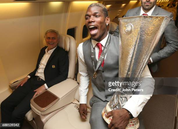 Paul Pogba and Manager Jose Mourinho of Manchester United celebrate with the Europa League trophy on the plane home after the UEFA Europa League...