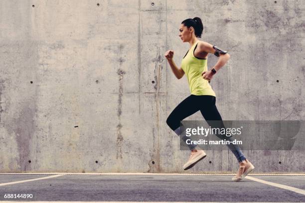 young athlete jogging outside - running stock pictures, royalty-free photos & images