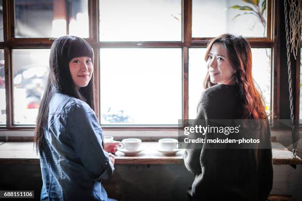 happy japanese womans relaxing holidays at the cafe - リラグゼーション stock pictures, royalty-free photos & images