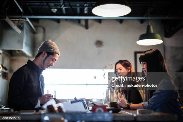 happy japanese womans relaxing holidays at the cafe - 真剣 stock pictures, royalty-free photos & images