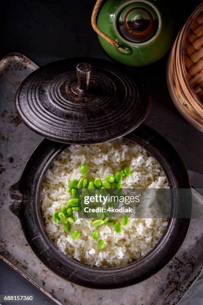 cooked white rice with edamame in a cast iron pot - white rice stock pictures, royalty-free photos & images