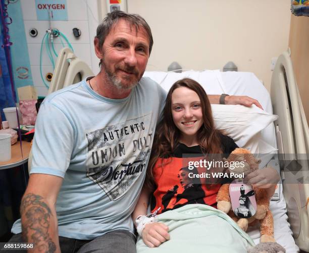 Millie Robson from Co Durham wearing an Arianna Grande t-shirt, a victim of Manchester Arena bombing with her dad, David as Queen Elizabeth II visits...