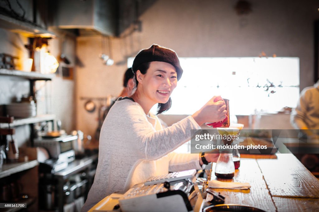 Happy Japanese woman cafe owner