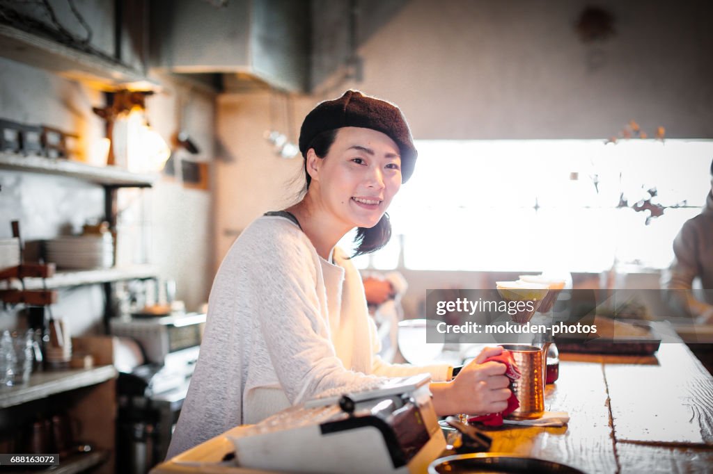 Happy Japanese woman cafe owner