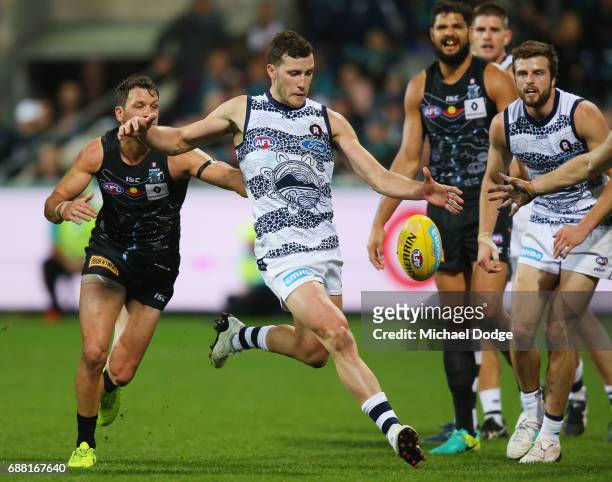 Sam Menegola of the Cats kicks the ball away from defence in the dying stages during the round ten AFL match between the Geelong Cats and the Port...