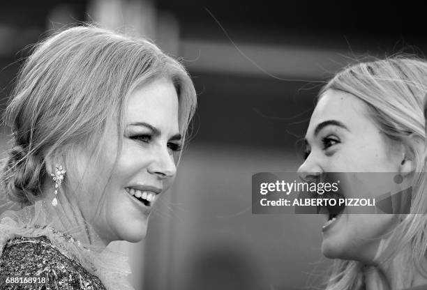 Australian actress Nicole Kidman and US actress Elle Fanning react as they arrive on May 21, 2017 for the screening of the film 'How to talk to Girls...