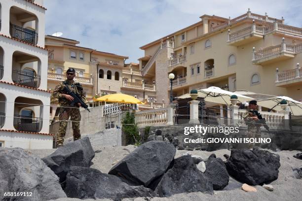 Italian soldiers control the access along the beach near the Media Center of the G7 in the coastal town of Giardini Naxos, south of Taormina, on May...